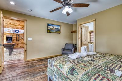 The Manor at Burg Hill upper level bedroom three with king size bed and 43 inch TV