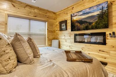 Midnight Bowling main level bedroom with 65 inch TV and year round electric fireplace