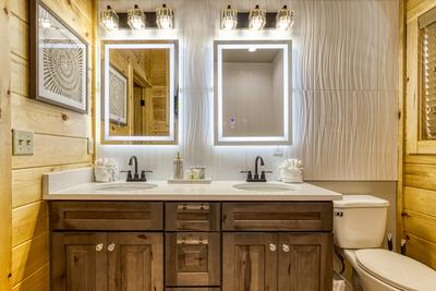 Midnight Bowling lower level bathroom with double vanities with heated mirrors
