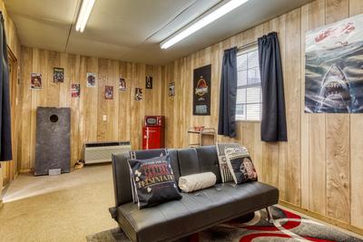 Lazy Man's Way entertainment shed with corn hole and futon