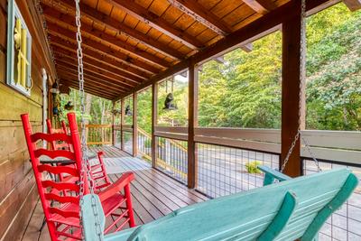 Sweet Tennessee Charm covered front deck with rocking chairs