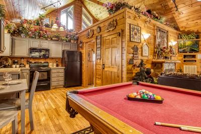 Wet and Wild living room, pool table, and fully furnished kitchen