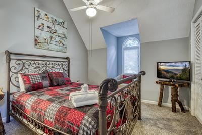 Feathers and Fur upper level bedroom with queen size bed and 32 inch TV
