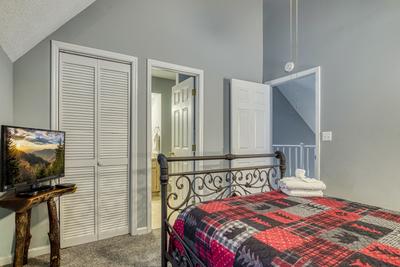 Feathers and Fur upper level bedroom with queen size bed and private bathroom