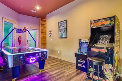 Smoky Mountain Gold game room with air hockey table and multiple arcade games