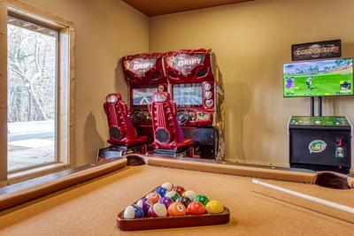 Smoky Mountain Gold game room with pool table, Ridge Racer racing game, and Golden Tee