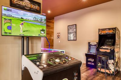 Smoky Mountain Gold game room with Golden Tee, air hockey table, and multiple arcade games