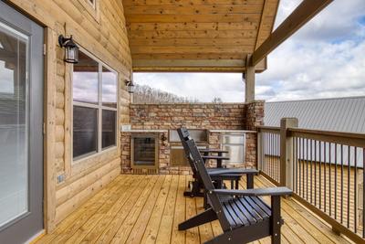 View to a Thrill main level deck with mountain views and outdoor kitchen