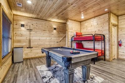 View to a Thrill lower level game room with pool table and bunk beds