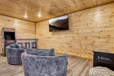 View to a Thrill lower level game room with 75 inch TV