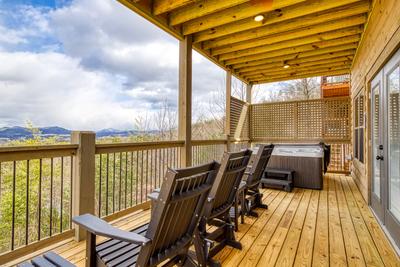 View to a Thrill lower level deck with mountain views and a hot tub