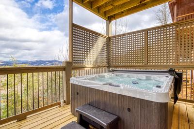 View to a Thrill lower level deck with a hot tub