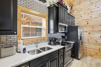 Let The Good Times Roll fully furnished kitchen with granite countertops