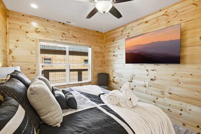 Let The Good Times Roll main level bedroom with 65 inch TV