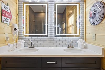 Let The Good Times Roll main level bathroom with heated and lit mirrors