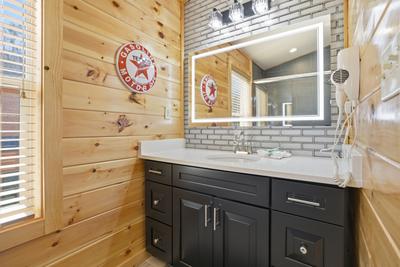 Let The Good Times Roll upper level bathroom with heated and lit mirror