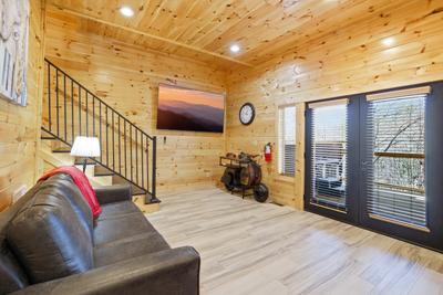 Let The Good Times Roll lower level sitting area with 85 inch TV