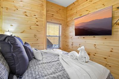 Let The Good Times Roll lower level bedroom with 65 inch TV