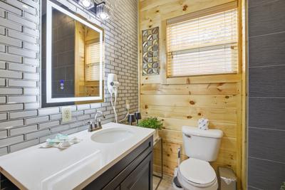 Let The Good Times Roll lower level bathroom with heated and lit mirror