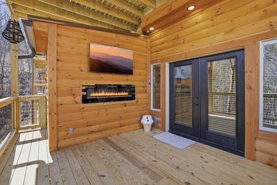 Let The Good Times Roll lower level deck with TV and fireplace