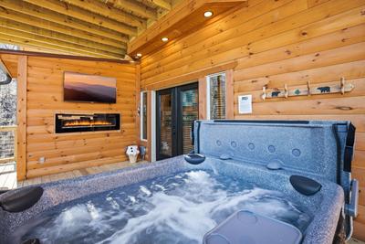 Let The Good Times Roll lower level deck with hot tub, fireplace, and TV