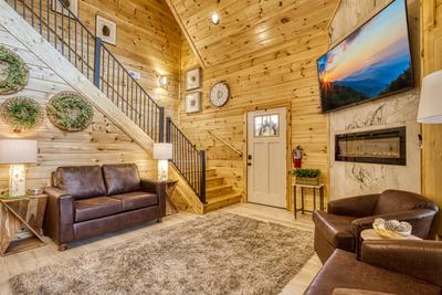 Firefly Strike Retreat living room with year round electric fireplace