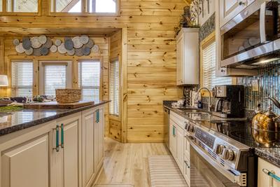 Firefly Strike Retreat fully furnished kitchen with granite countertops and stainless steel appliances