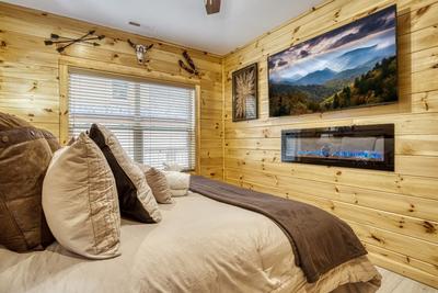 Firefly Strike Retreat main level bedroom with 65 inch TV