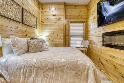 Firefly Strike Retreat lower level bedroom with king size bed and 65 inch TV