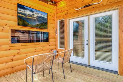 Firefly Strike Retreat lower level deck with 55 inch TV and year round electric fireplace