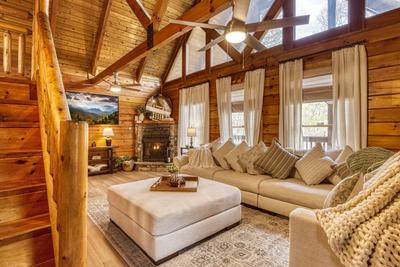 Sweet Dreams living room with sectional sofa and seasonal stone encased gas fireplace