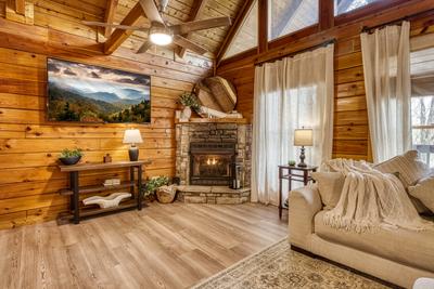 Sweet Dreams living room with seasonal stone encased gas fireplace