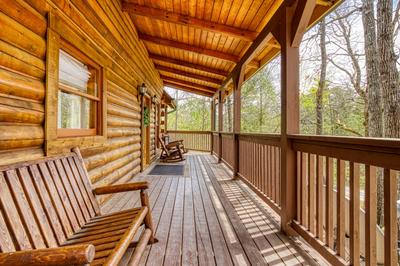 Sweet Dreams covered wrap around deck with rocking chairs