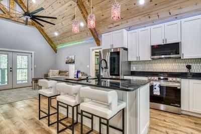 Mountain Lake Home bar top and fully furnished kitchen with granite countertops