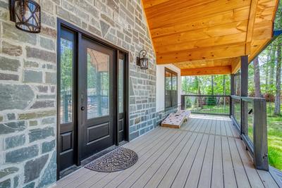 Mountain Lake Home covered entry deck with corn hole