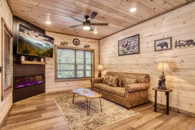Honey Bear living room with year round electric fireplace and 65 inch TV