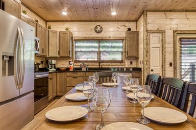 Honey Bear fully furnished kitchen with stainless steel appliances and dinging table