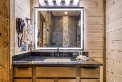Honey Bear main level bathroom with single vanity with a heated mirror