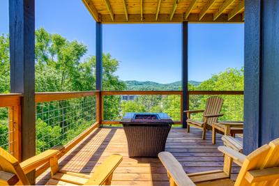 Honey Bear main level deck with mountain and city views and a propane fireplace