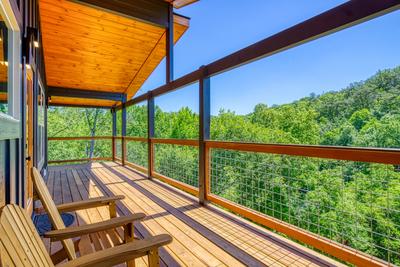 Honey Bear upper level covered wrap around deck with mountain views