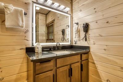 Honey Bear lower level bathroom with a single vanity with a heated mirror