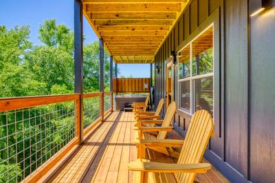 Honey Bear lower level covered wrap around deck with hot tub and mountain views