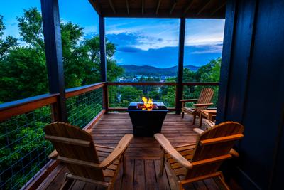 Honey Bear main level wrap around deck with propane fire pit and view of Pigeon Forge