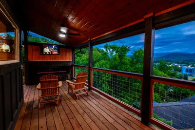 Honey Bear covered wrap around deck with TV and year round electric fireplace