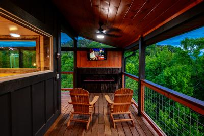 Honey Bear TV and year round electric fireplace on covered wrap around deck