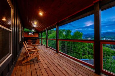 Honey Bear covered wrap around deck with year round electric fireplace and TV