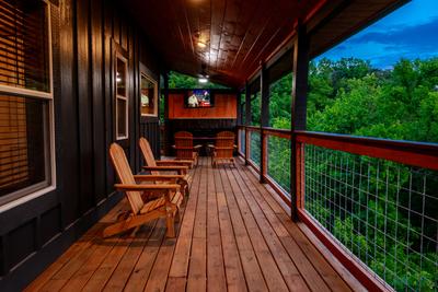 Honey Bear covered wrap around deck with TV and year round electric fireplace
