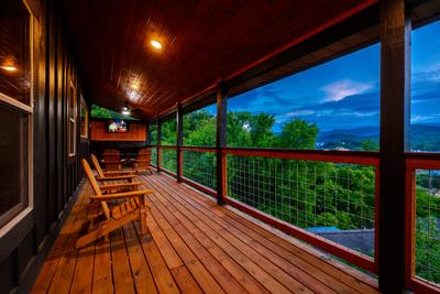 Honey Bear sitting area and covered wrap around deck with TV and year round electric fireplace