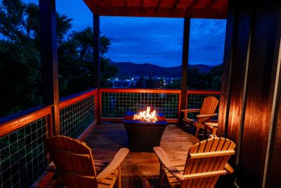 Honey Bear propane fire pit at night on wrap around deck