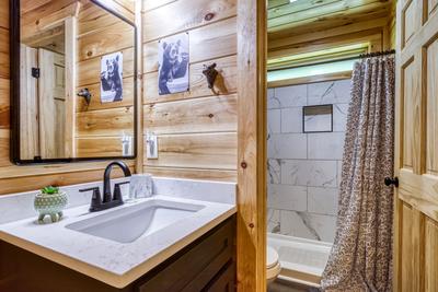 Mountain Memories main level bathroom with single vanity and walk in shower